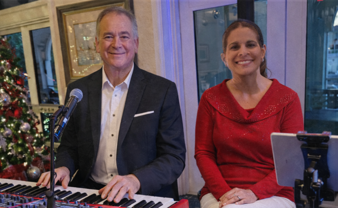Deano and Marvilla performing during a holiday club event